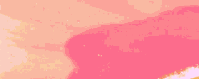 a close up of a pink and orange paint brush stroke .