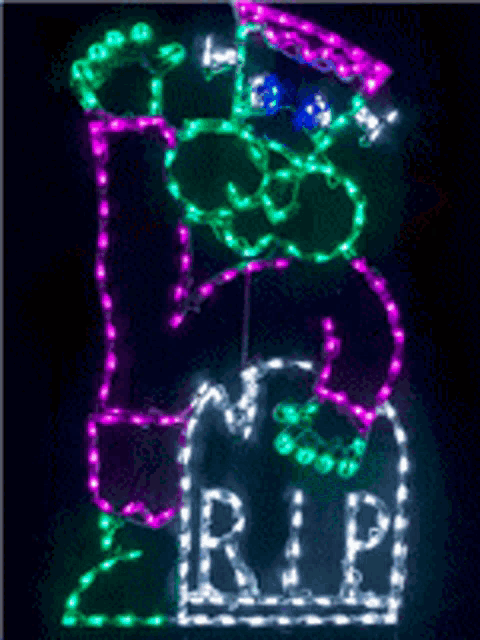 a sign that says rip is lit up in green and purple
