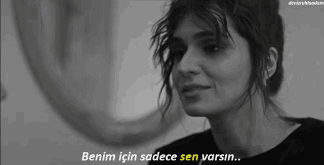 a black and white photo of a woman with the words benim için sadece sen varsin