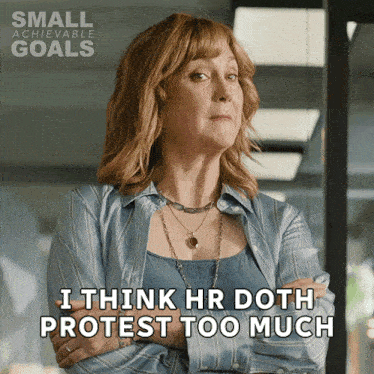 a woman says " i think hr doth protest too much " with her arms crossed