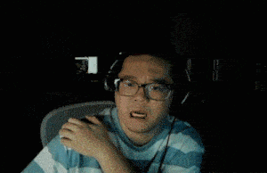 a man wearing glasses and headphones is making a face