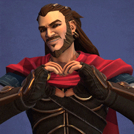 a man with long hair and a beard is making a heart with his hands