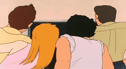 a group of people are looking at a tv screen