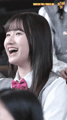 a girl is laughing with the words watch full video on jk48 tv below her
