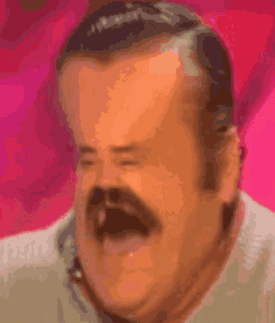 a close up of a man 's face with a pink background