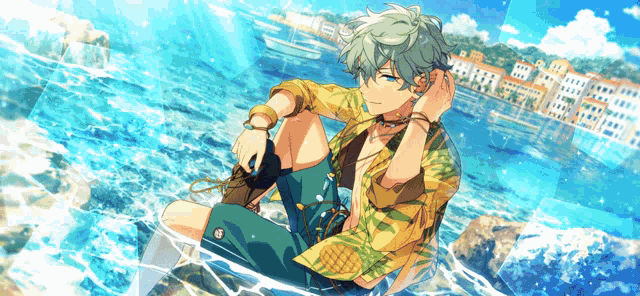 a boy is sitting on a rock in the ocean .