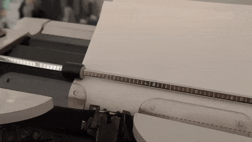 a typewriter with a ruler on it that shows the numbers 1 through 10