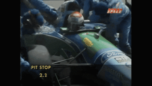 a ford racing car is being worked on by mechanics
