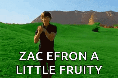 a man standing in a grassy field with the words zac efron a little fruity above him