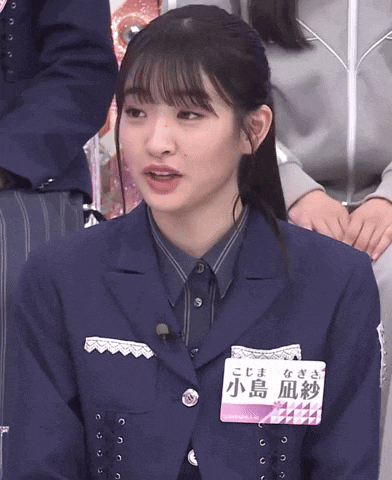 a girl in a suit has a name tag that says ' aoi ' on it