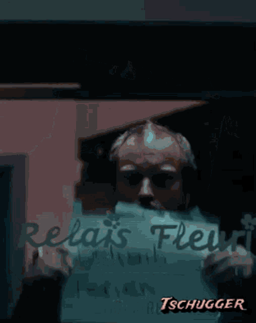 a man is holding a piece of paper that says " relax flex "