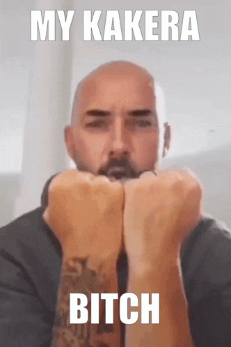 a man with a tattoo on his arm is holding his fist up with the words my kakera bitch written above him
