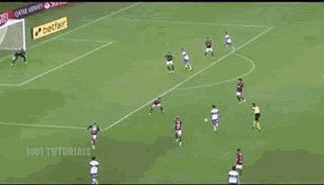 a soccer field with advertisements for qatar airways amstel and ford ford