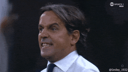 a man in a white shirt and tie is on a sports 1 live channel