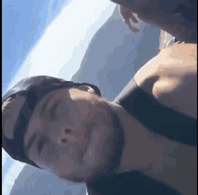 a man wearing a helmet and goggles looks down at something