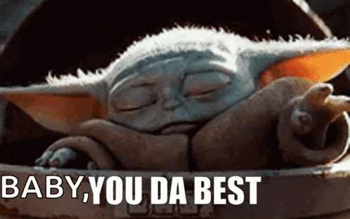 a baby yoda from star wars is sleeping in a bucket with the words `` baby , you da best '' written on it .