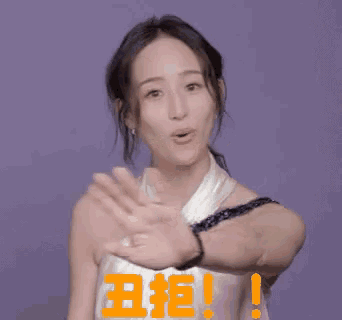 a woman in a white dress is giving a high five