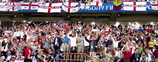 a crowd of people in a stadium with a banner that says rochdale afc on it