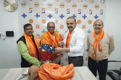 a man in an orange scarf is giving a bouquet of flowers