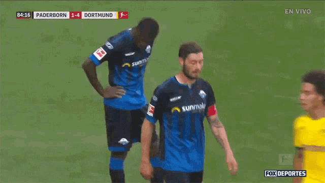 a soccer game between paderborn and dortmund is being played