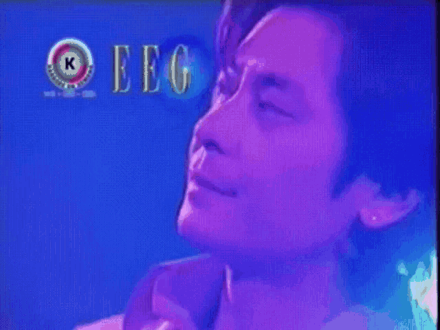 a close up of a man 's face with the letters eeg on the bottom