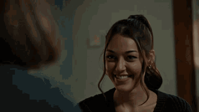 a woman giving another woman a high five in front of her face