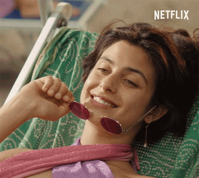 a woman is laying in a chair with a netflix logo in the corner
