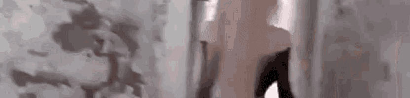 a woman is standing in front of a wall in a bathroom .