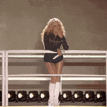 a woman standing on a stage with a microphone in her hand