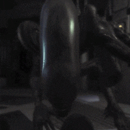 a close up of a statue of a monster in a dark room .