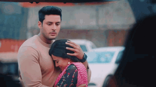 a man is holding a woman 's head in his arms