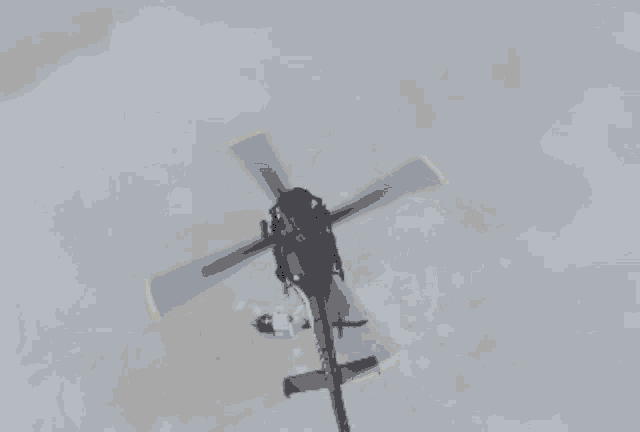 a helicopter is flying over an explosion with smoke coming out of it