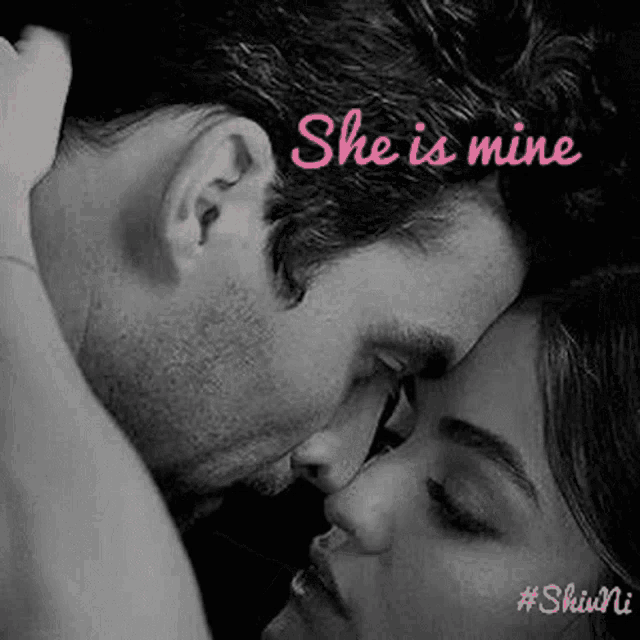 a black and white photo of a man and woman kissing with the words she is mine written above them