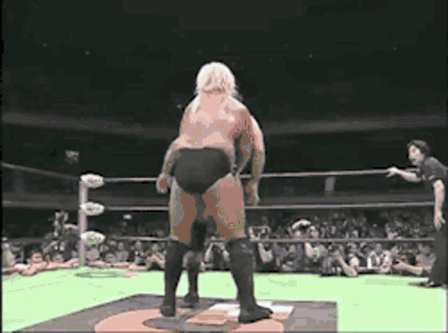 a man in a wrestling ring with a crowd watching