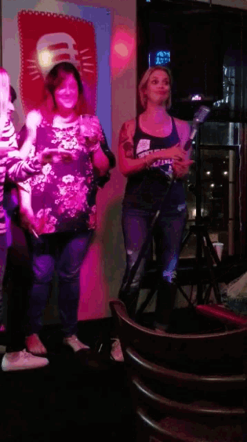 a woman wearing a black tank top that says numb on it