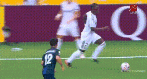 a soccer player with the number 12 on his jersey is kicking the ball