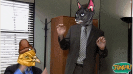 a man in a suit has a cat mask on his face