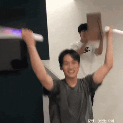 a man in a nike shirt is holding a light stick