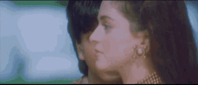a man and a woman are looking at each other in a movie .