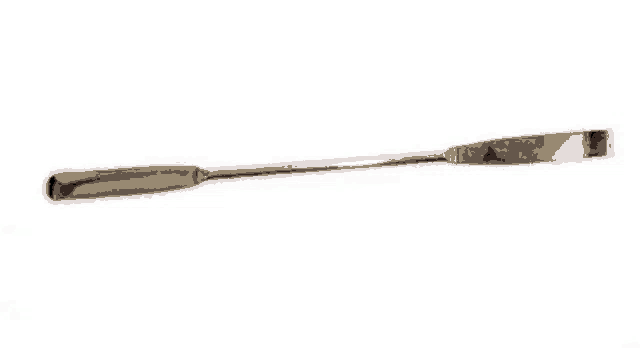 a spatula with a black handle is sitting on a white surface .