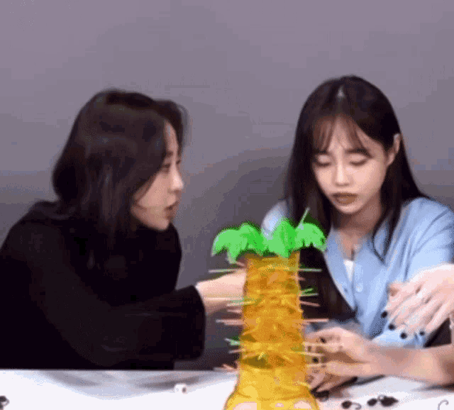 two girls are playing a game with a monkey tower