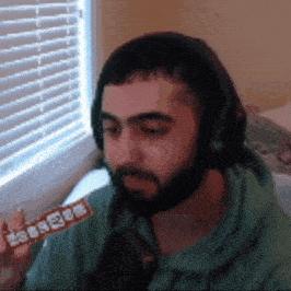 a man wearing headphones is eating a bar of chocolate