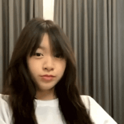 a young woman with long hair is wearing a white shirt .