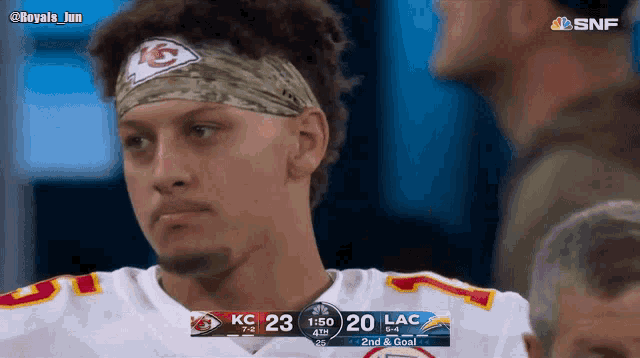 a football player wearing a headband with a kc on it