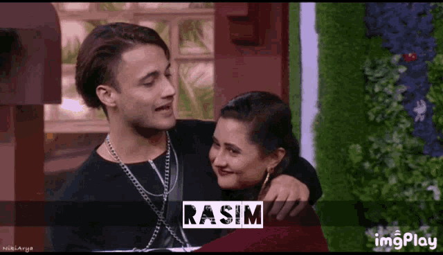 a man and a woman hugging with the name rasim on the bottom right