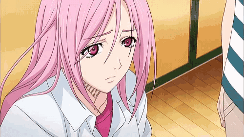 a girl with pink hair and red eyes is sitting on the floor looking down .