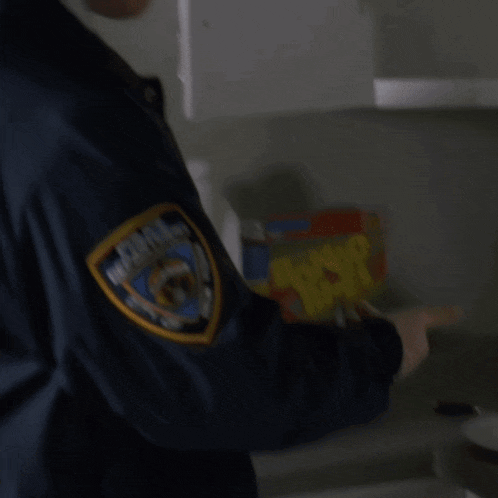 a man in a blue jacket with a patch that says police department on it
