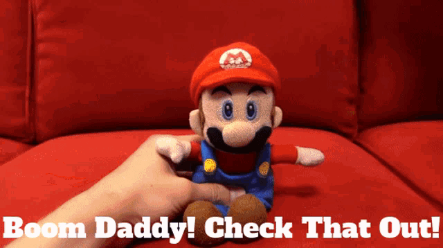 a person holding a stuffed mario with the words boom daddy check that out