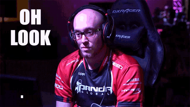 a man wearing headphones is sitting in a chair with the words oh look behind him