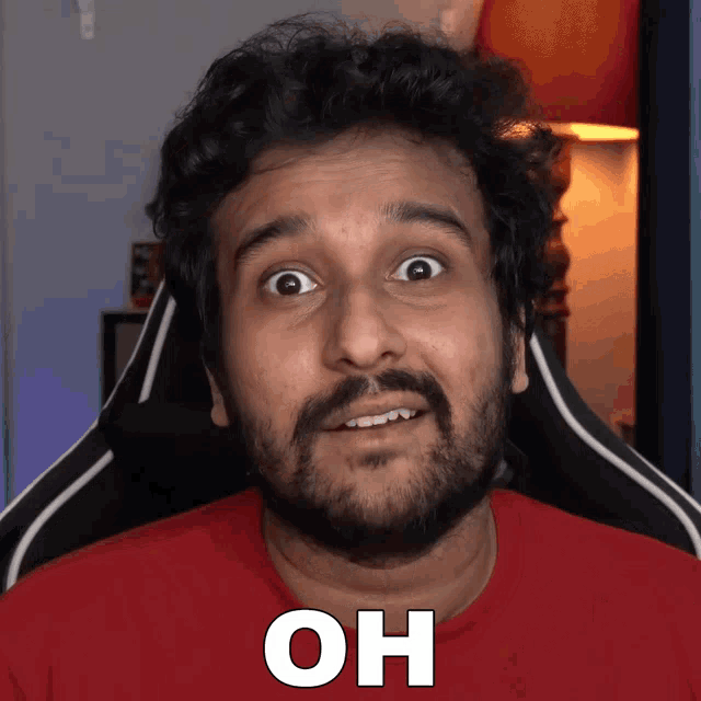 a man with a beard wearing a red shirt has the word oh on his face